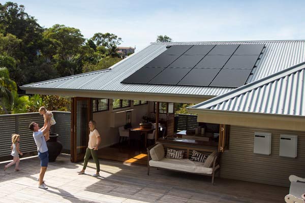 Silhouette solar panels on roof of house.